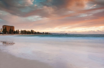 Scenic view of beach against sky during sunset