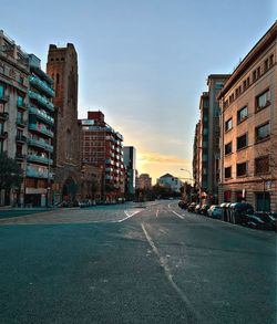 Surface level of road by buildings against sky