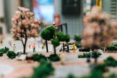 Tilt-shift image of people on street in city