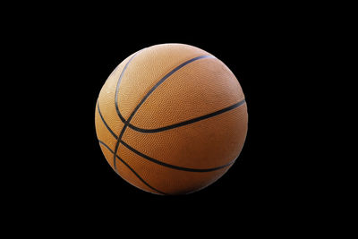 Close-up of ball hanging against black background