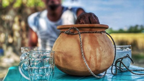Close-up of man in jar on table