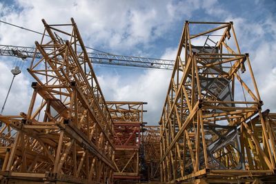 Low angle view of crane against sky