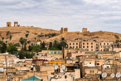 Buildings in town against sky