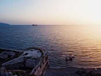 Scenic view of sea against clear sky during sunset