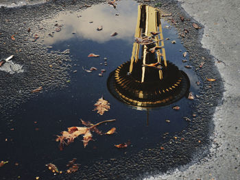 High angle view of the space needle in a wet puddle on the street