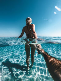 Full length of woman in swimming pool against sea