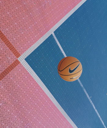 HIGH ANGLE VIEW OF BASKETBALL HOOP AGAINST BLUE BACKGROUND