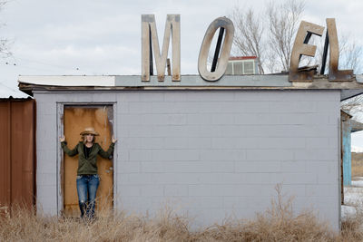 Men on house against sky