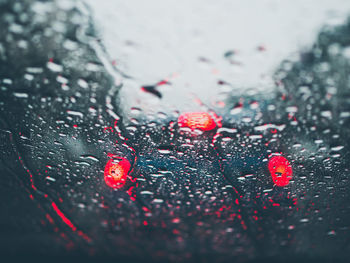 Close-up of wet glass window during rainy season