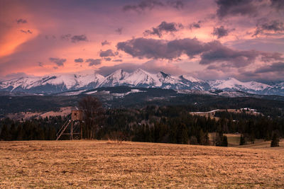 Scenic view of snowcapped mountains against sky during sunset