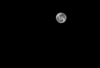 Low angle view of moon against sky at night