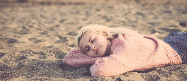 Woman sleeping on sand