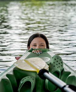 Portrait of woman holding a boat in lake