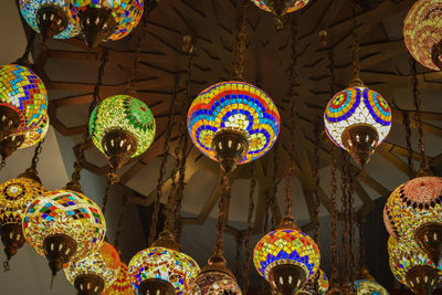 Low angle view of illuminated lanterns hanging from ceiling