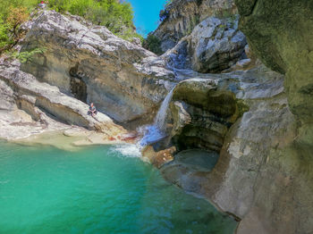 People on rocks at shore