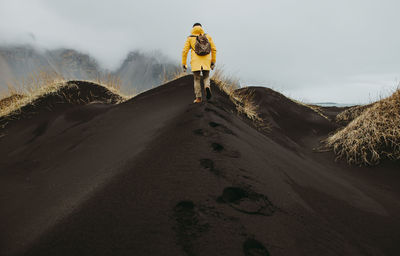 Man on black sand in desert