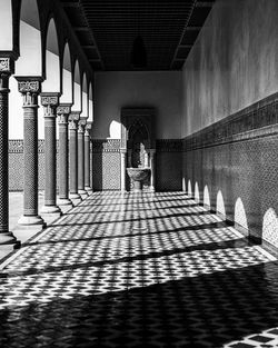 Rear view of woman walking in corridor of building