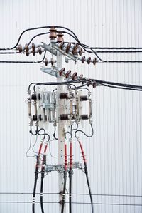 Close-up of electric lamp hanging on wall