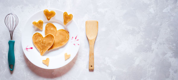 Creative breakfast for valentine's day. heart shaped pancakes with strawberries on a plate