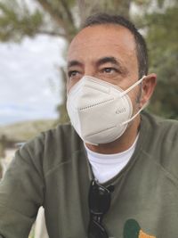 Close-up of man wearing mask looking away