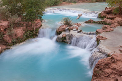 Scenic view of river flowing through rocks