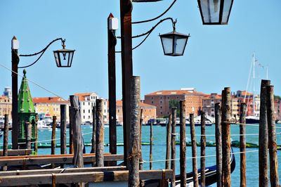 City street by sea against clear blue sky