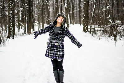 High angle view of woman standing on tree trunk