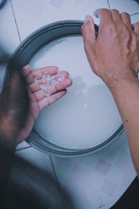 High angle view of person cleaning rice in kitchen at home