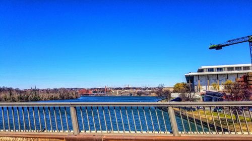 Scenic view of buildings against clear blue sky