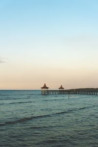Scenic view of sea against clear sky during sunset