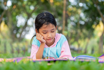 Portrait of cute girl sitting outdoors