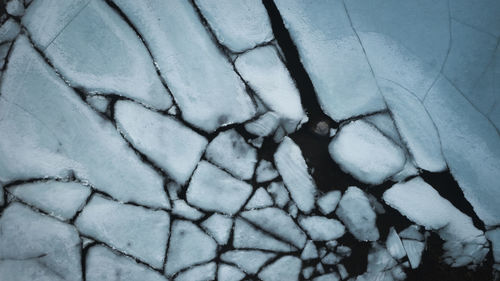 High angle view of snow on cobblestone