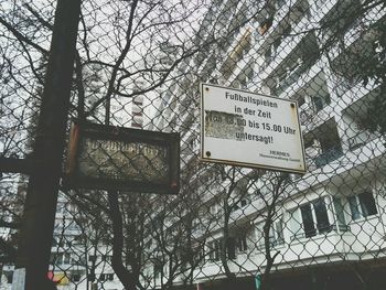 Low angle view of sign board against sky