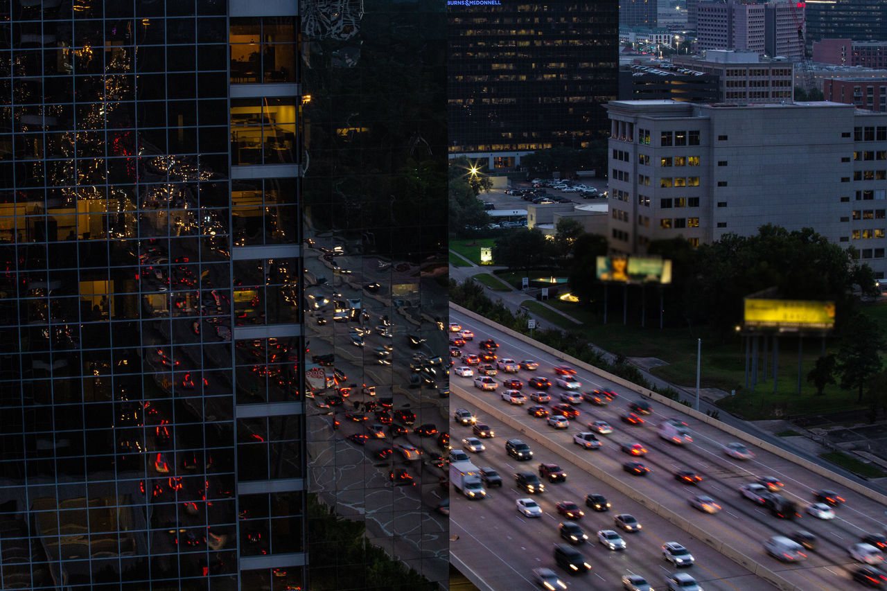 HIGH ANGLE VIEW OF ILLUMINATED STREET AMIDST BUILDINGS AT NIGHT