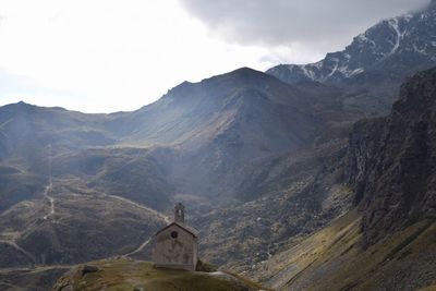Scenic view of mountains against cloudy sky