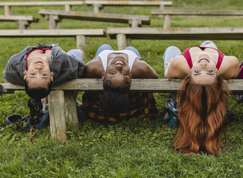 Happy young women resting on bench in park