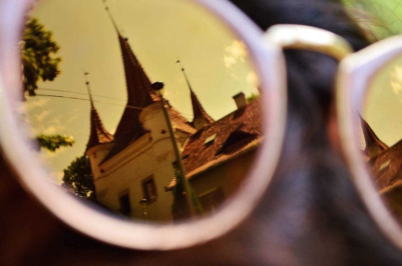 CLOSE-UP OF SUNGLASSES ON GLASS