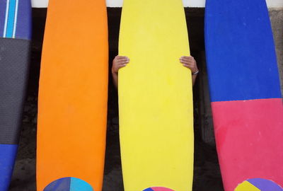 Close-up of yellow flags against blue sky