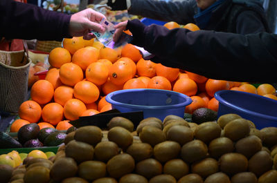 People exchanging money at market stall