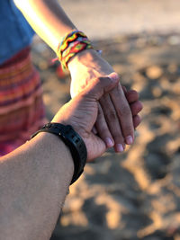 Midsection of man holding hands