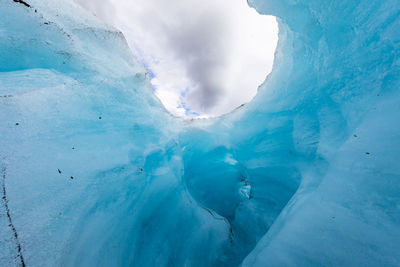 Low angle view of ice formation against cloudy sky