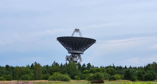 The silhouette of a satellite dish or radio antenna. space observatory or air defense radar.