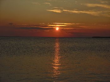 Scenic view of sea against orange sky