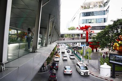 Traffic on road amidst buildings in city