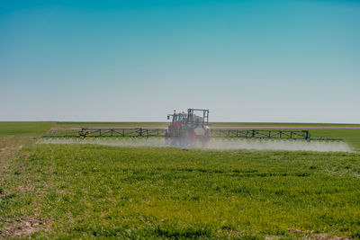 Scenic view of agricultural field against clear sky