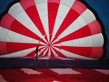 Man standing by hot air balloon