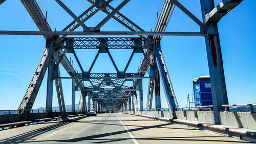 Low angle view of bridge against clear blue sky