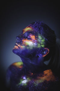 Conceptual shot of light and shine fluorescent colors young girl's fac