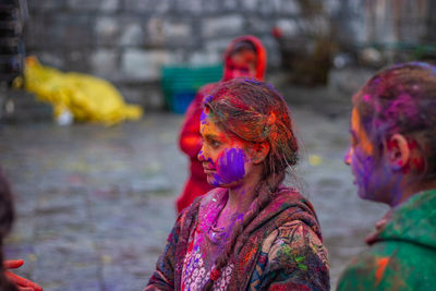 Portrait of multi colored painting in background