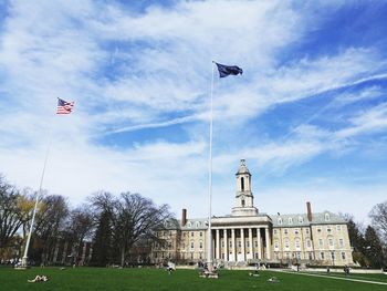 Low angle view of flags against sky